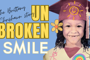 A young Brittany Chrishawn with her two front teeth missing while wearing a kindergarten graduation gown and hat. There's also text on the page that reads "Unbroken Smile"