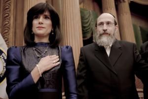 A jewish couple, the wife is being sworn in as the judge inside a courthouse