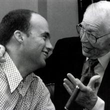 A black-and-white photo of director Dean Ward with Milton Berle smiling while in conversation. 