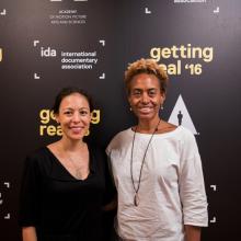 Marcia Smith (right) posing with Sonia Kennebeck (left) in front of step and repeat with IDA, Getting Real '16 and Academy of Motion Picture Arts and Sciences logos.
