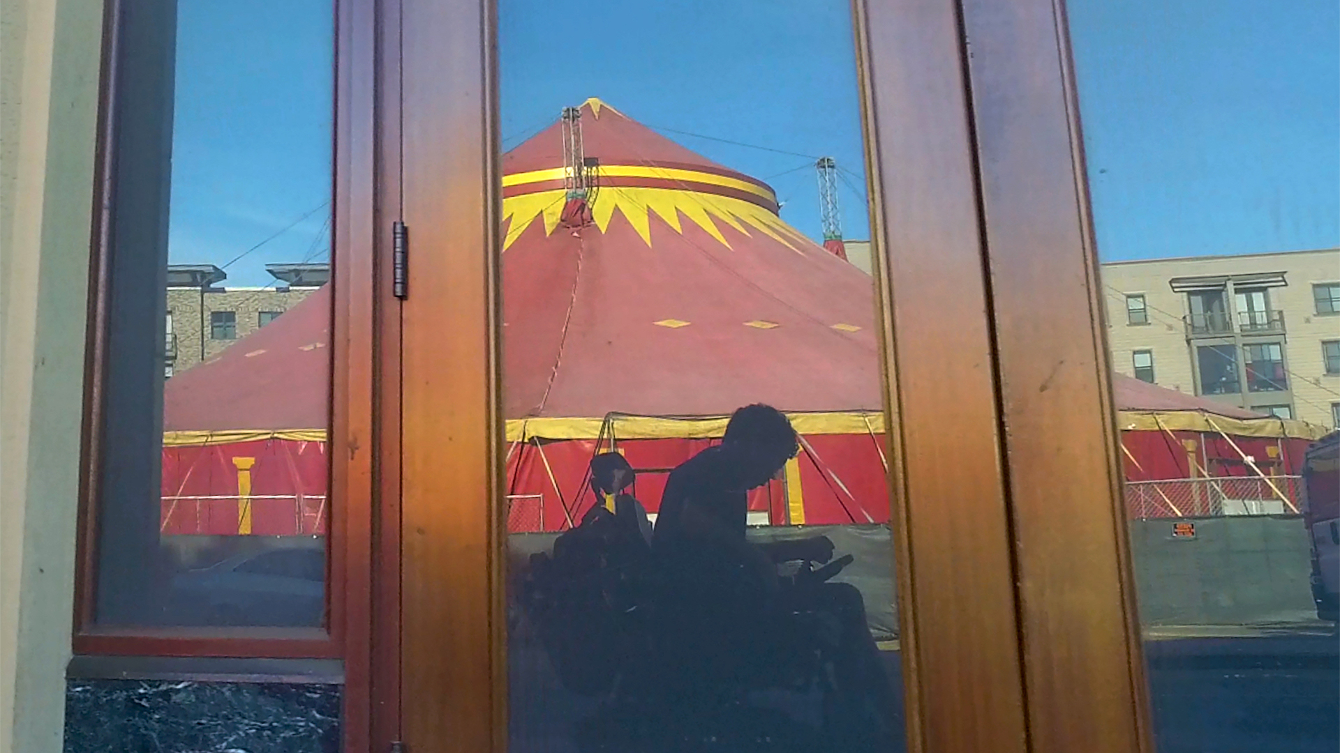 Filmmaker Reid Davenport, a wheelchair user, sits in front of a circus tent. From Davenport's I Didn’t See You There: Courtesy of ‘POV’.'