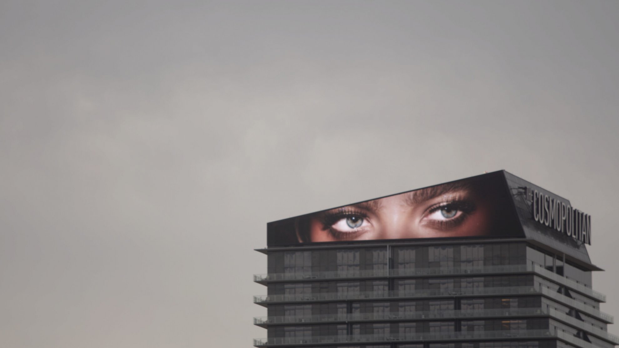 An image of a pair of eyes displayed on a screen atop a skyscraper. From Todd Chandler’s 'Bulletproof.' Courtesy of Grasshopper Film.