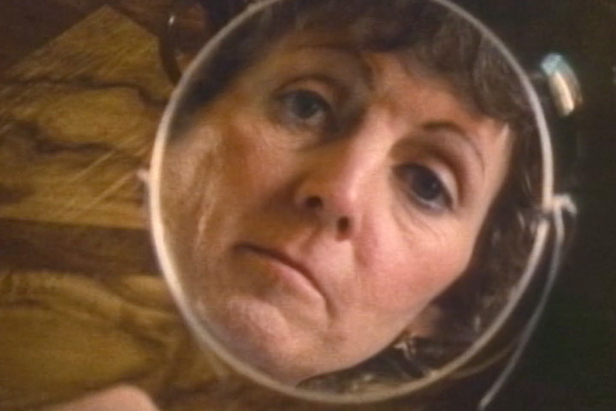 A protagonist looks into a hand-held mirror in Lee Grant's 'What Sex Am I?' Courtesy of Criterion Channel