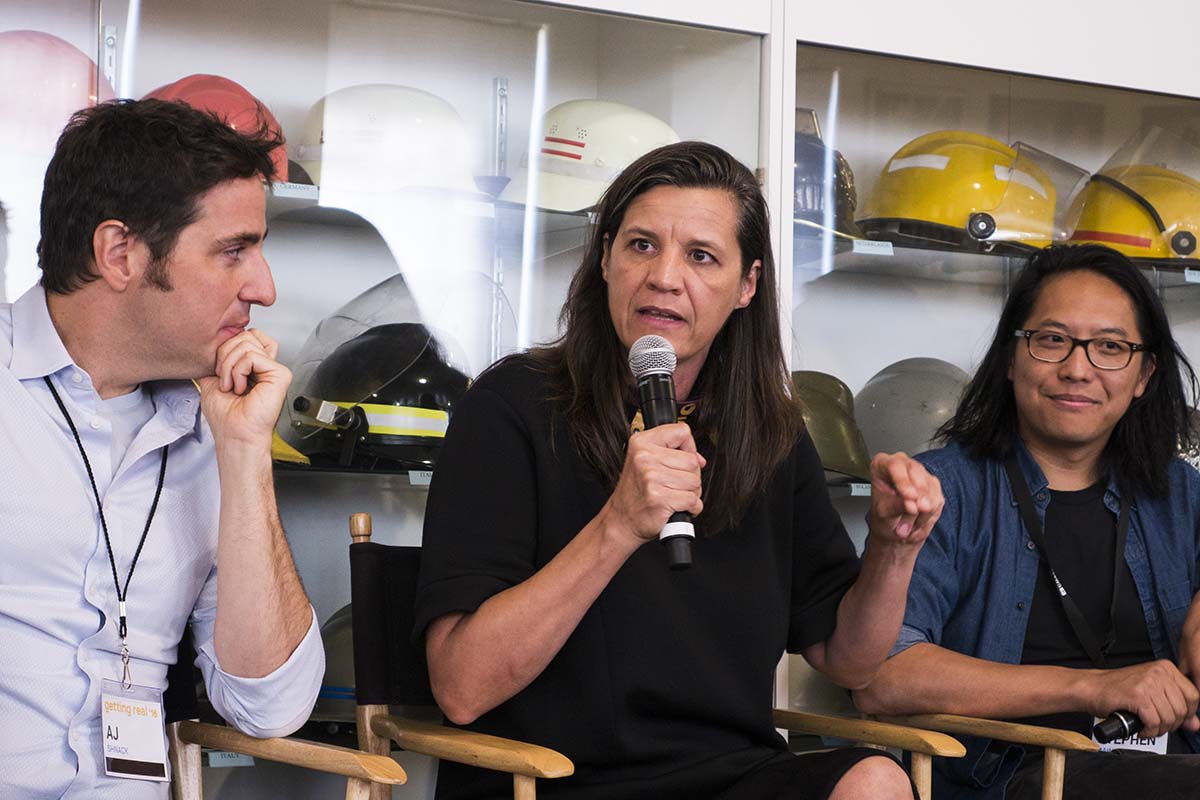Kisrten Johnson is a white female filmmaker, seen here speaking at the 2016 Getting Real conference, along with filmmakers AJ Shnack and Steve Maing. Photo by Susan Yin.