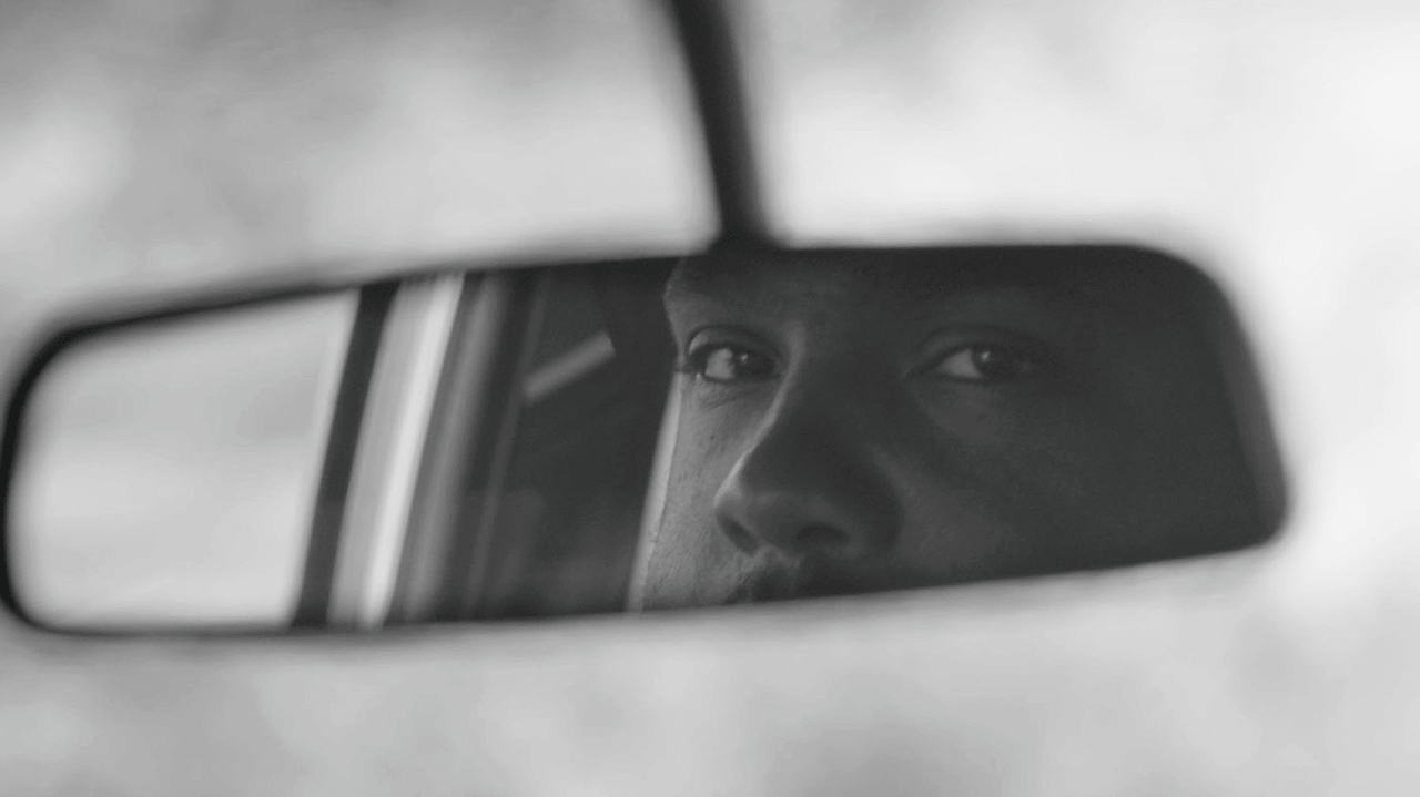 The eyes of a Black male driver reflected in a car's rearview mirror. From Geeta Gandbhir and Sam Pollard’s 'Lowndes County and the Road to Black Power.' Courtesy of Tribeca Festival. 