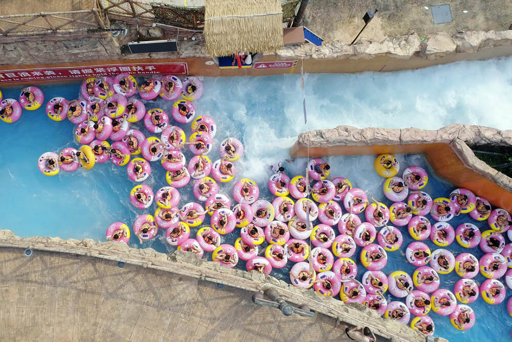 Drone shot of many pink plastic ring floats on a water ride. A scene from ‘Ascension’ (Directed by Jessica Kingdon, Produced by Kira Simon-Kennedy, Jessica Kingdon, Nathan Truesdell). Courtesy of Tribeca Film Festival