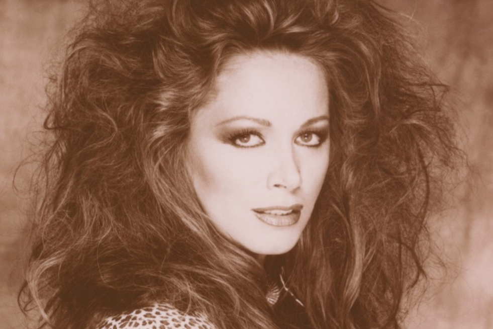 A sepia portrait of Jackie Collins, a white woman with permed hair and a leopard print blouse. Still from ‘LADY BOSS: The Jackie Collins Story’ (Directed by Laura Fairrie, Produced by John Battsek, Lizzie Gillett) Courtesy of Tribeca Film Festival