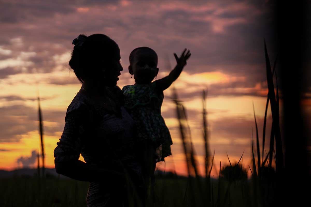  A silhouette of a woman holding a child against a sunset sky. From Hnin Ei Hlaing’s ‘Midwives,’ which recently played at Hot Docs. Courtesy of Hot Docs.