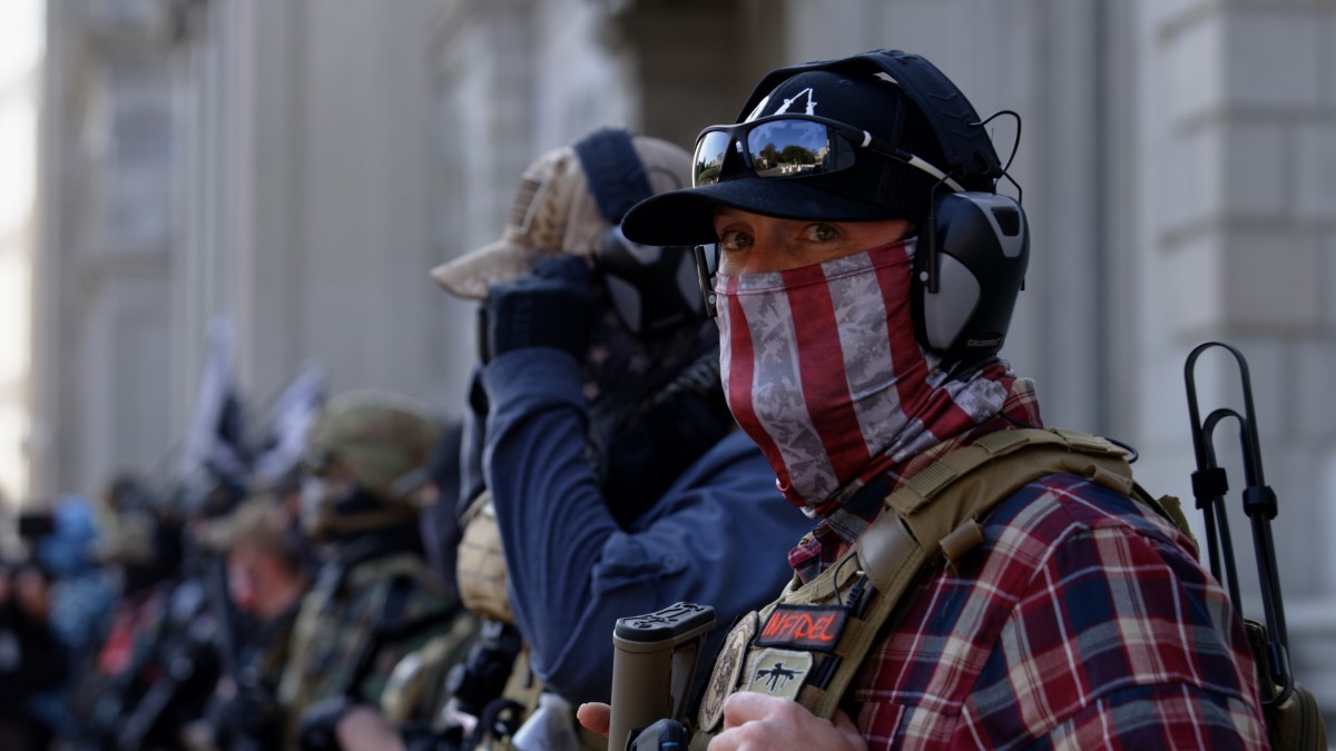 2 far-right extremists, dressed in flannel shirts, bullet-proof vests and baseball caps, outside the US Capitol on January 6.