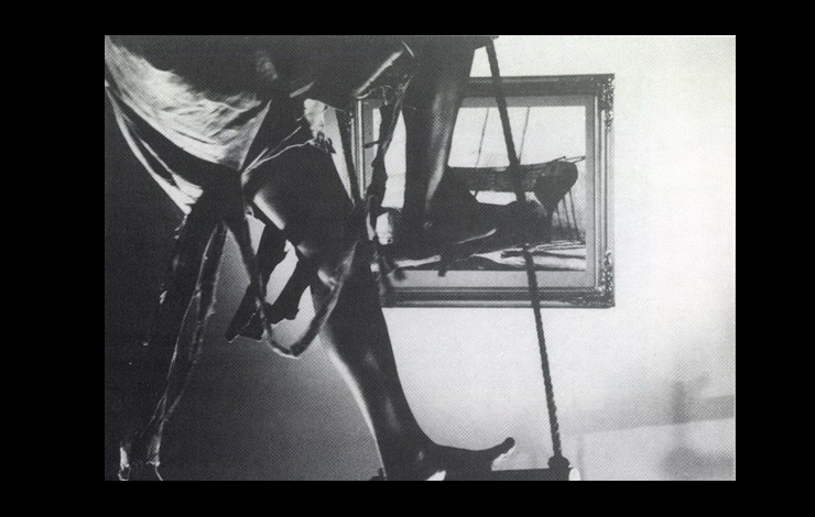 An abstract black and white photo of a leg and a mirror. Nice Colored Girls, by Tracey Moffat