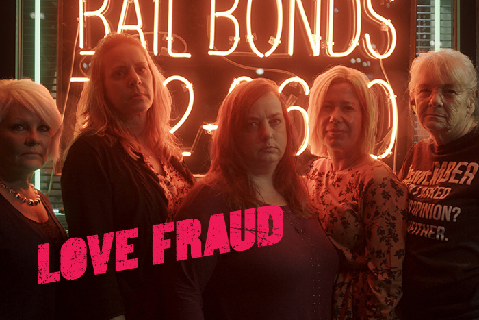A group of middle-aged women standing in front of a bail bonds neon sign