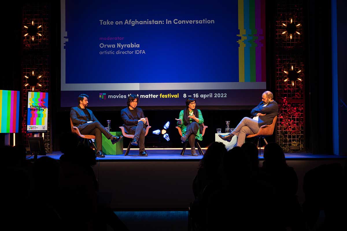 (L-R) Filmmakers Dawood Hilmandi, Aboozar Amini and Sahra Mani in a conversation moderated by IDFA's Artistic Director Orwa Nyrabia. From Movies that Matter 2022’s  ‘Take on Afghanistan: In Conversation’ panel. Photo by Eelkje Colmjon.
