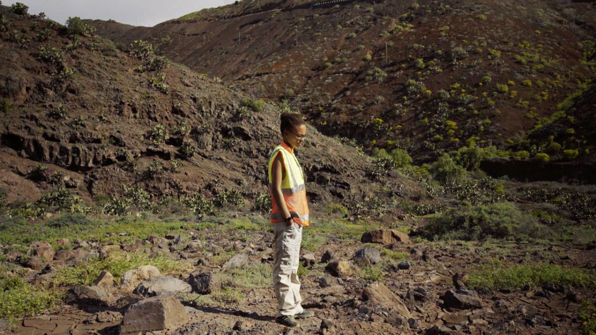 Activist Annina van Neel stands on a mass burial site in St Helena. From Joseph Curran and Dominic de Vere's 'A Story of Bones.' Courtesy of Tribeca Festival.