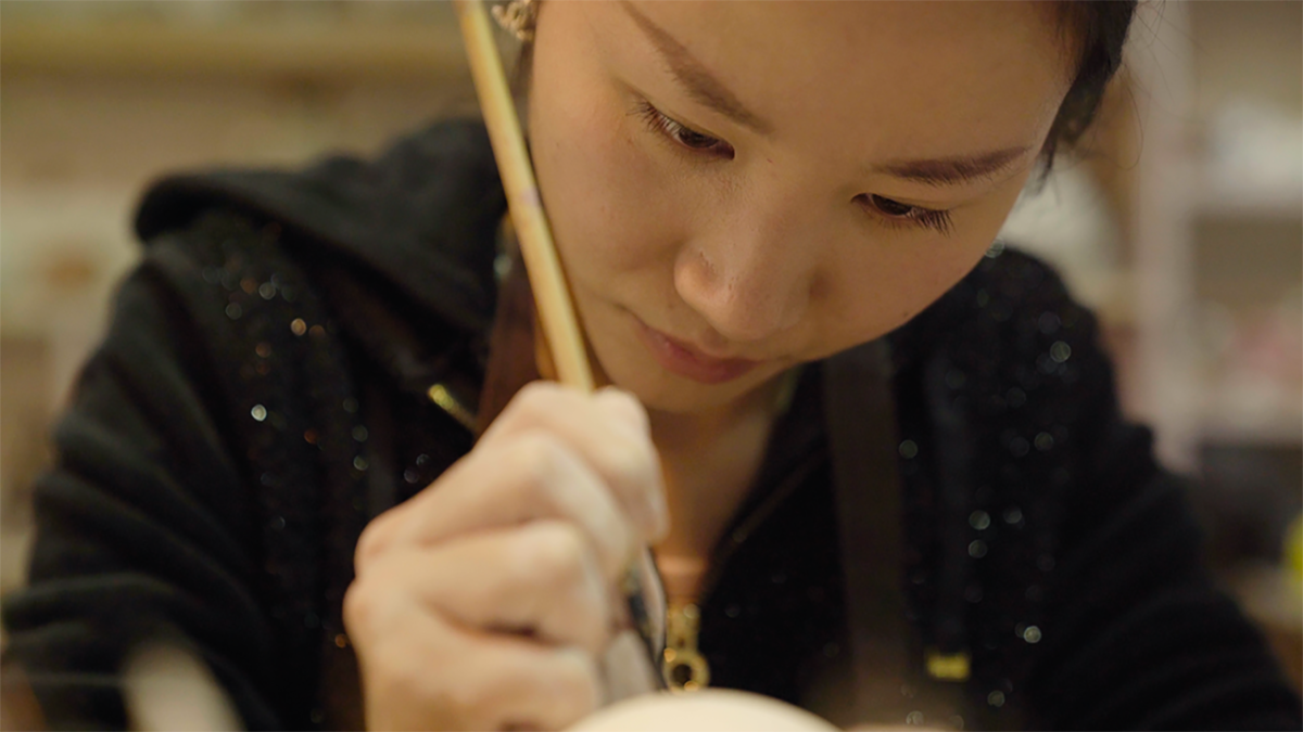 A Chinese woman seen writing with a calligraphy pen. From Violet Feng's 'Hidden Letters.' Courtesy of Tribeca Festival.