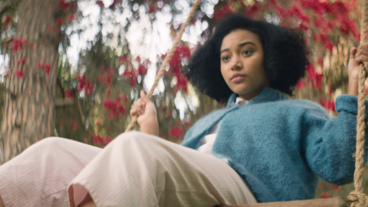 A young Black woman seen on a swing. She is wearing a blue sweater. From Pratibha Parmar's 'My Name Is Andrea.' Courtesy of Tribeca Festival.