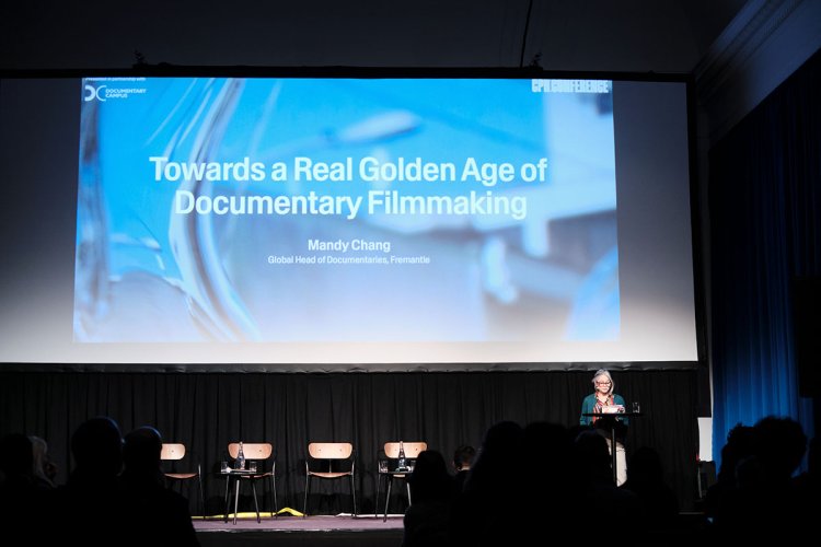 Mandy Chang is a woman of Asian descent. She is standing at a podium with a screen behind her. It reads “Towards a Real Golden Age of Documentary Filmmaking.” Courtesy of CPH: Conference.