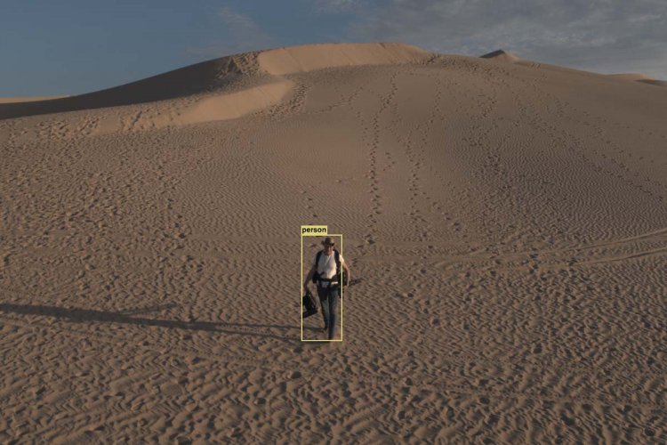 Artist Trevoe Raglen is a white man in a white shirt and jeans, walking through a desert. There is a CGI yellow rectangle drawn around him. From Yaara Bou Melhem’s ‘Unseen Skies.’ Courtesy of Full Frame Film Festival.