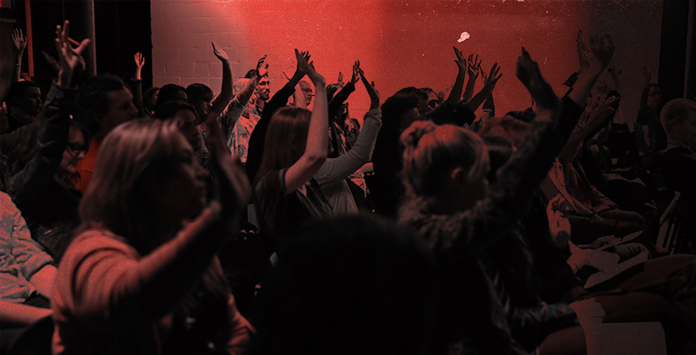 Audience raising their hands