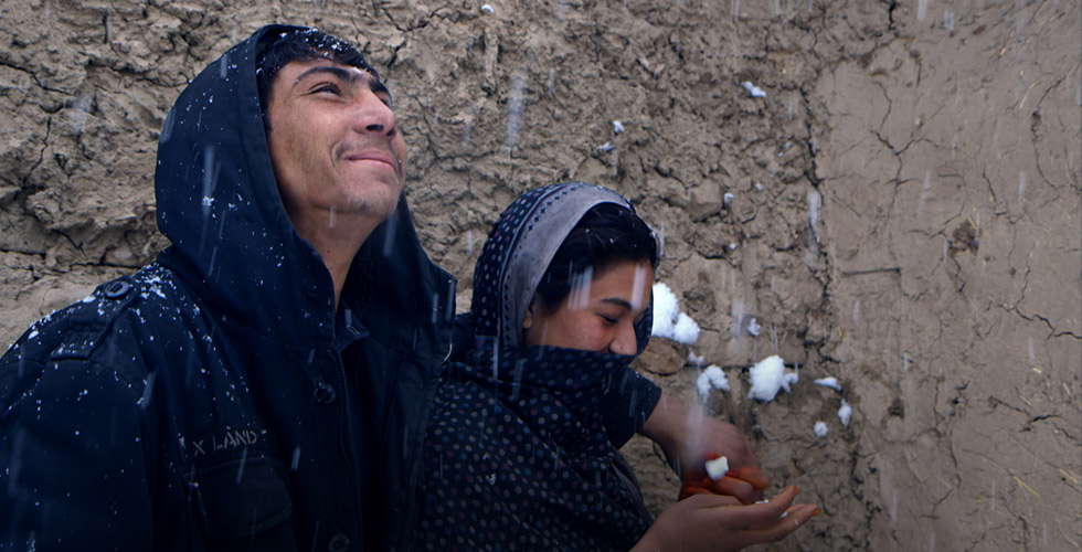 A young Afghan couple pictured in the snow. Image from Elizabeth and Gulistan Mirzaei’s ‘Three Songs for Benazir,’ which was set and filmed in refugee camps in Afghanistan.