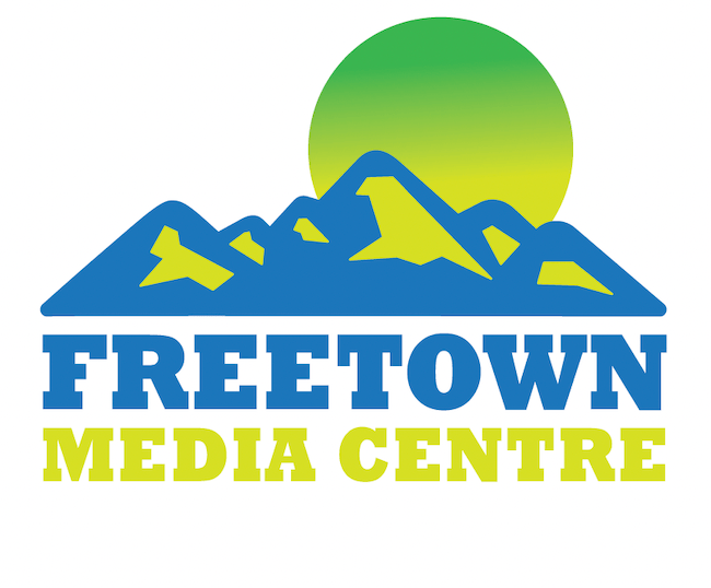 Logo: A green sun rises over a mountain range. Underneath the mountain is the text "Freetown Media Center"