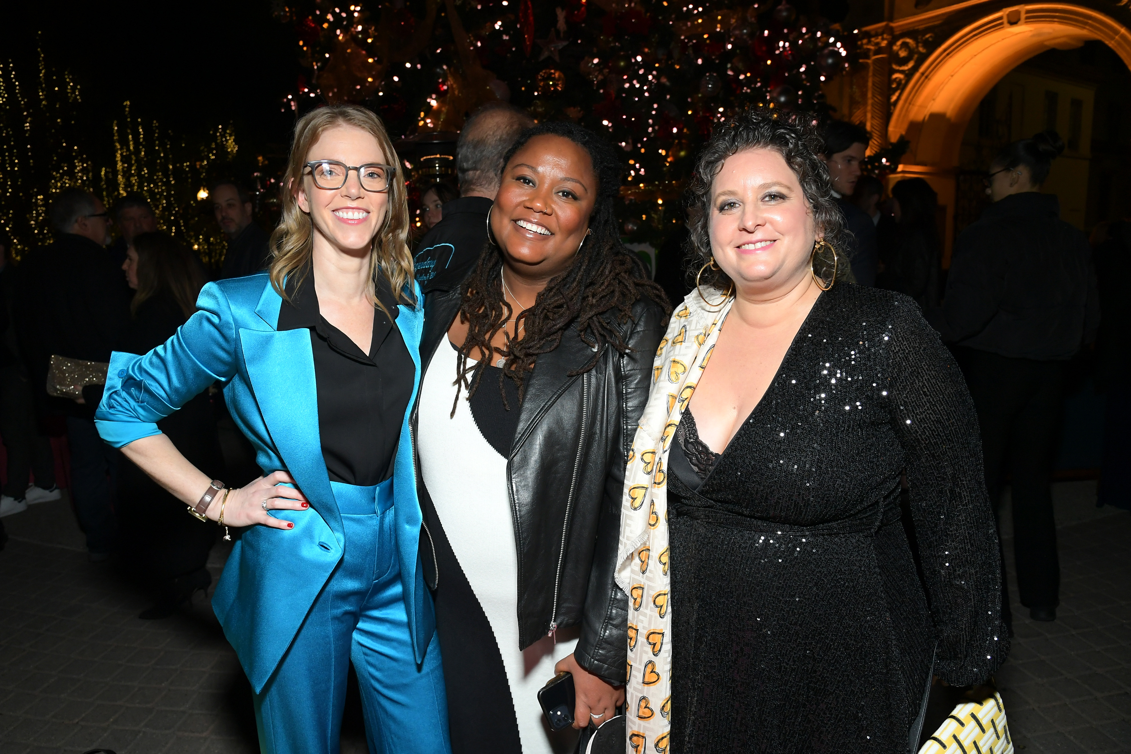 Three guests smile at an IDA gathering.