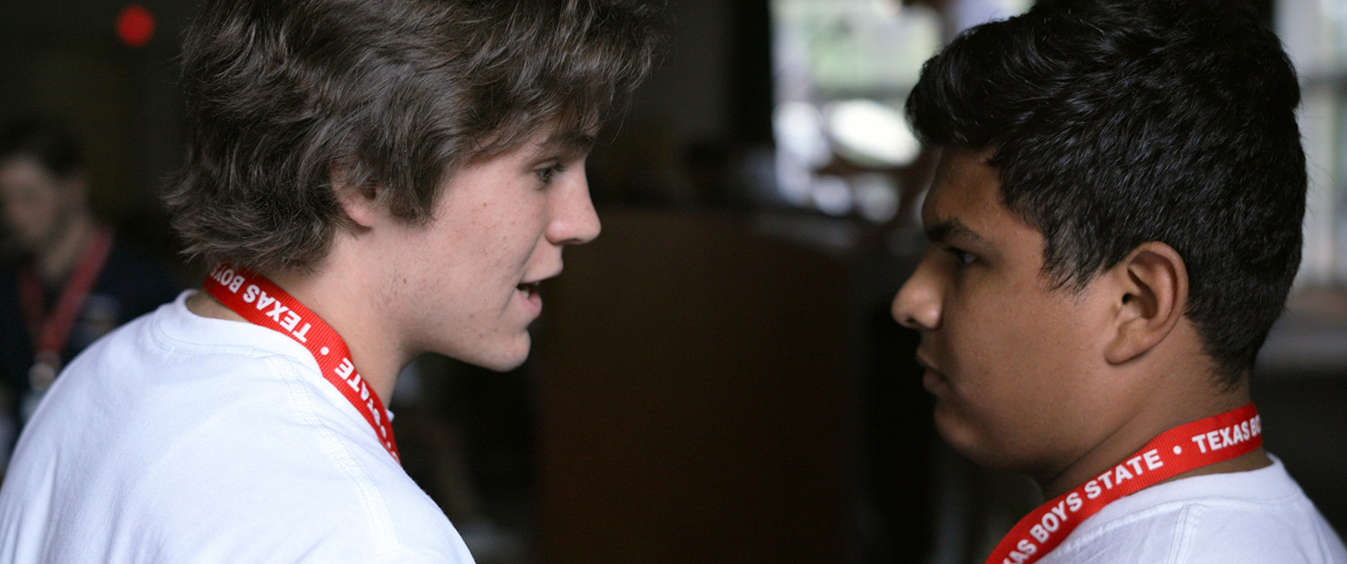 Robert MacDougall (left) and Steven Garza, protagonists from Jesse Moss and Amanda McBaine’s 'Boys State', confer during the Nationalists Run-Off Debates. Courtesy of Apple
