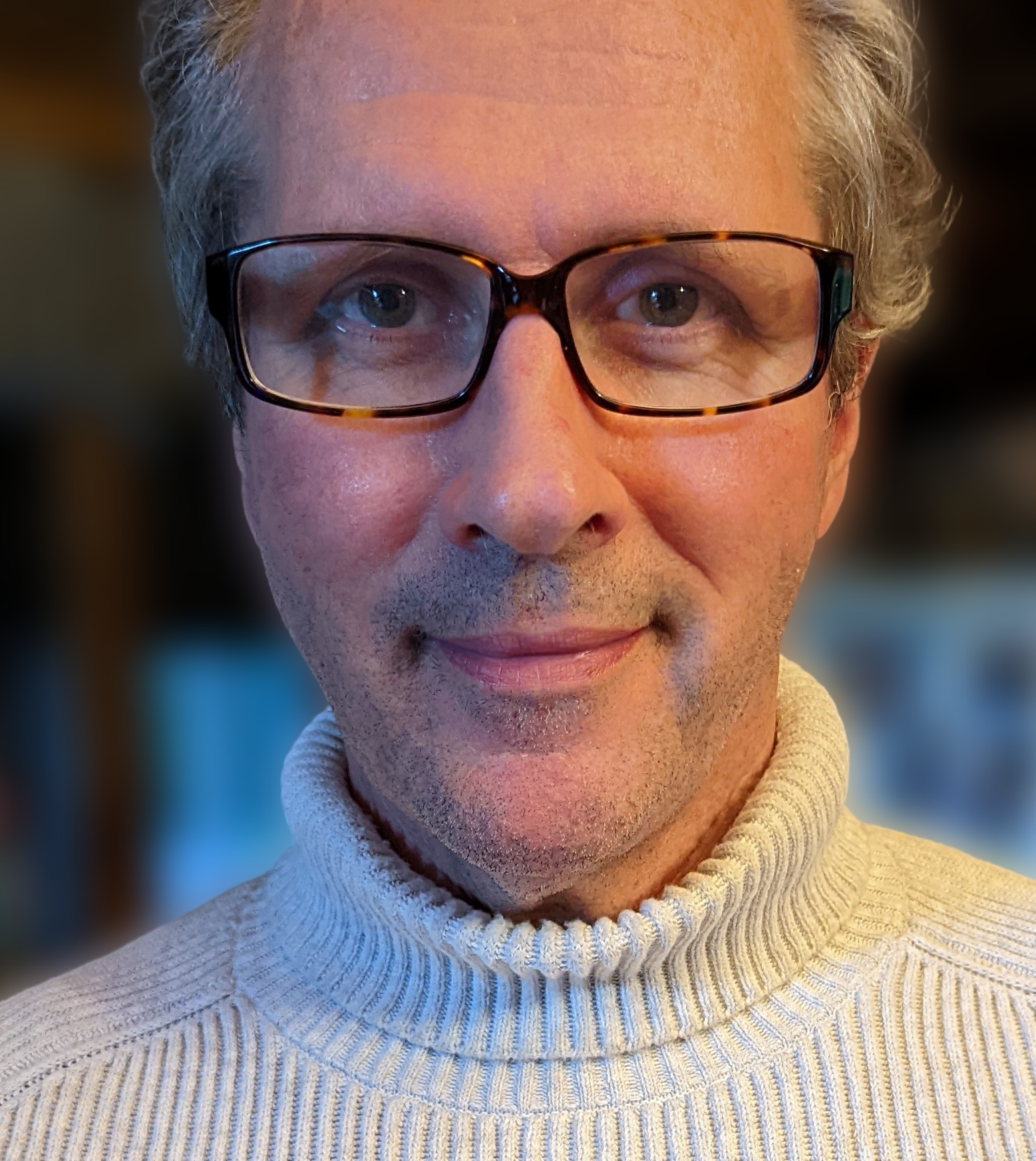 Image ID: Headshot of a middle aged male of white descent wearing a white jumper