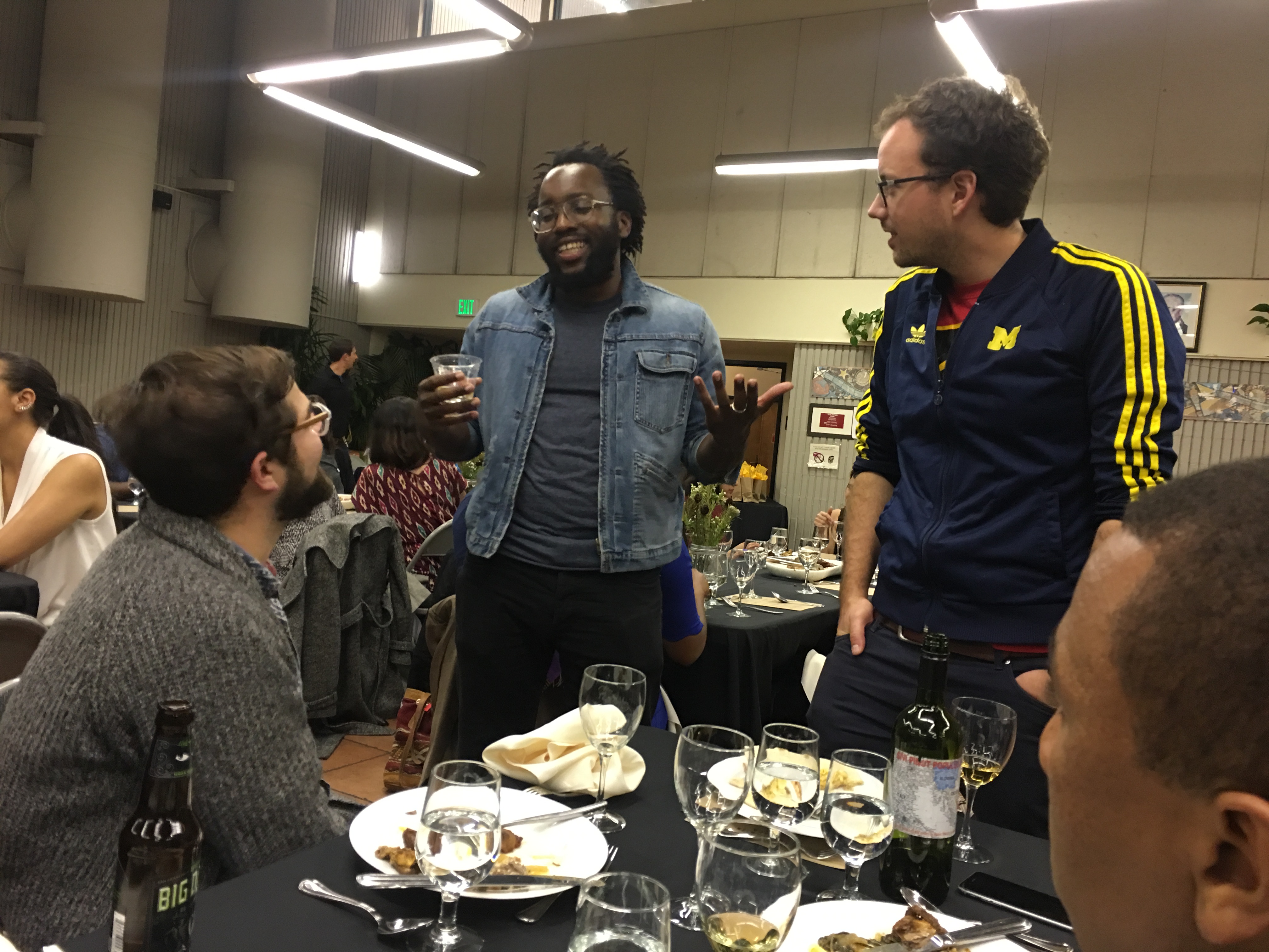 Right: Theo serves guests at Tunde’s Blackness in America dinner in November 2016. Credit: Meaghan M. Mitchell.