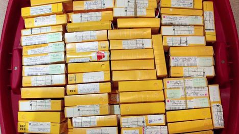 A red box filled with small yellow boxes of film