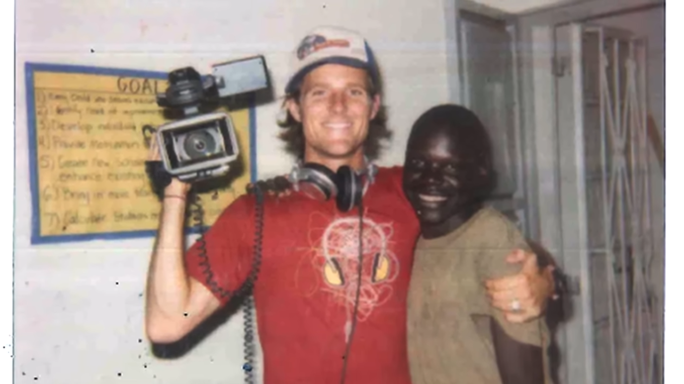 A white man hugs a Black man.