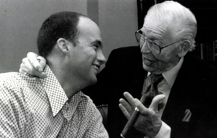 A black-and-white photo of director Dean Ward with Milton Berle smiling while in conversation. 
