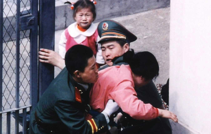 Two-year-old Kim Han-mi looks on in agony as her mother is wrestled to the ground by Chinese guards at the Japanese consulate in Shenyang, China. From 'Seoul Train.' Courtesy of Incite Productions