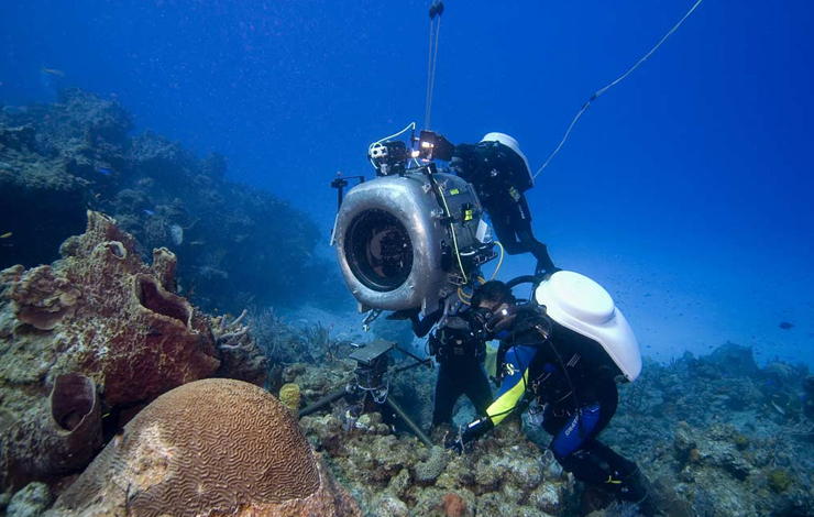 Howard Hall and IMAX film crew using IMAX 3-D camera underwater during making of 'Deep Sea 3-D'