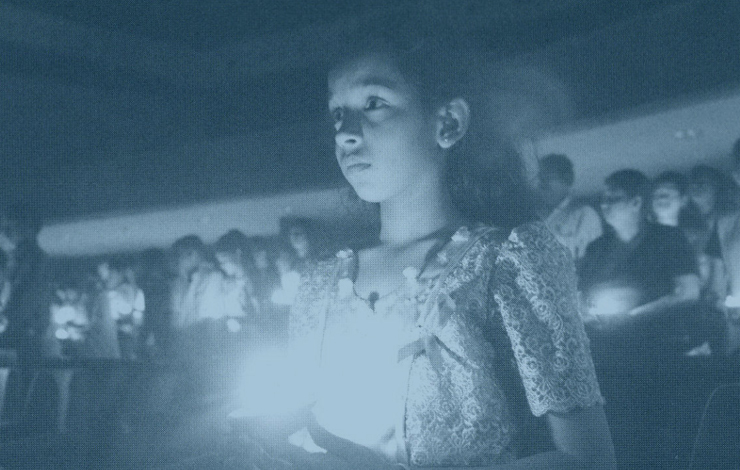 A young Sri Lankan girl takes part in a candlelight memorial for AIDS victims. From the Frontline documentary 'The Age of AIDS.'