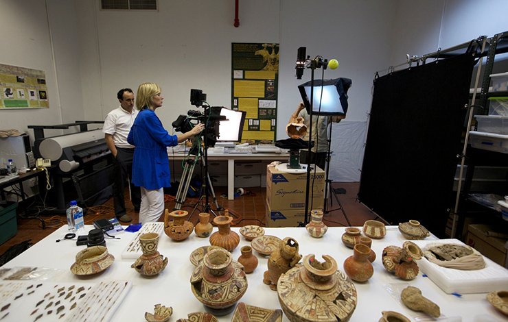 Filmmaker Maggie Burnette Stogner filming ancient artifacts in Panama for the <em>Indiana Jones and the Adventure of Archaeology </em>exhibition. Courtesy of Maggie Burnette Stogner