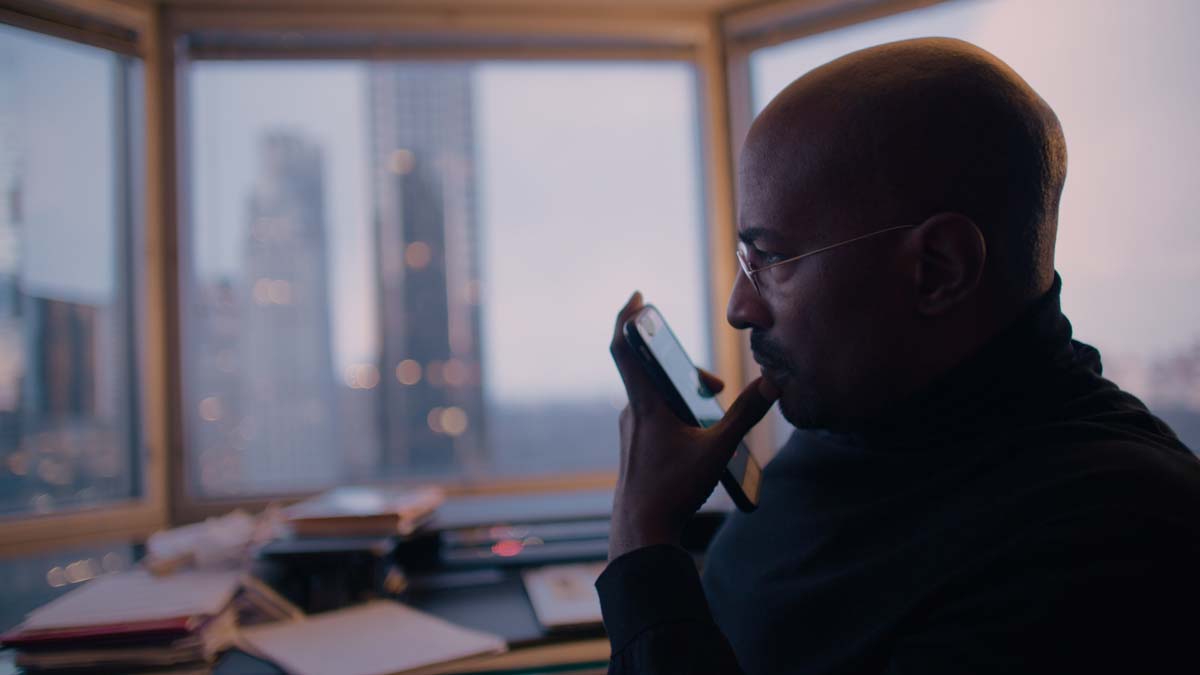 Side profile of Van Jones, a bald Black man holding a cellphone, wearing glasses. From Brandon and Lance Kramer’s ‘The First Step.’ Courtesy of AFI Docs.