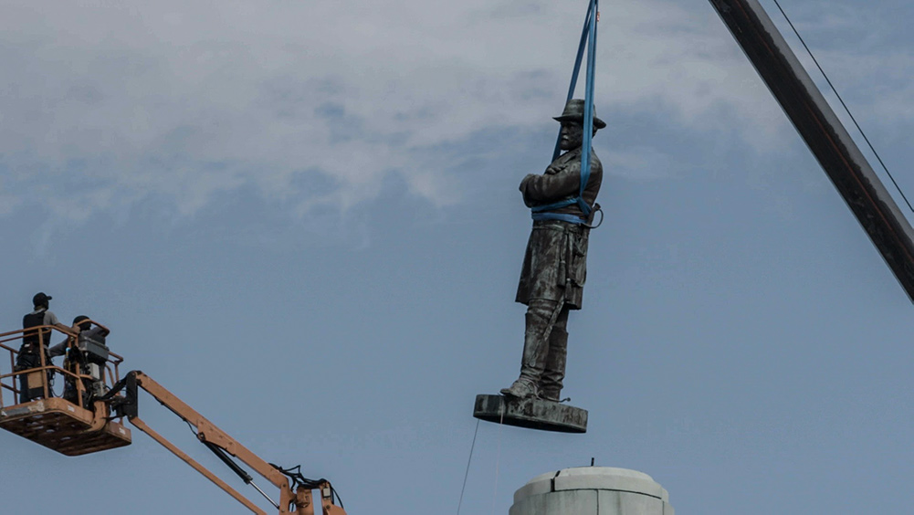 A crane removing a black-colored Confederate statue. A still from CJ Hunt’s ‘The Neutral Ground.’ Courtesy of ‘POV.'