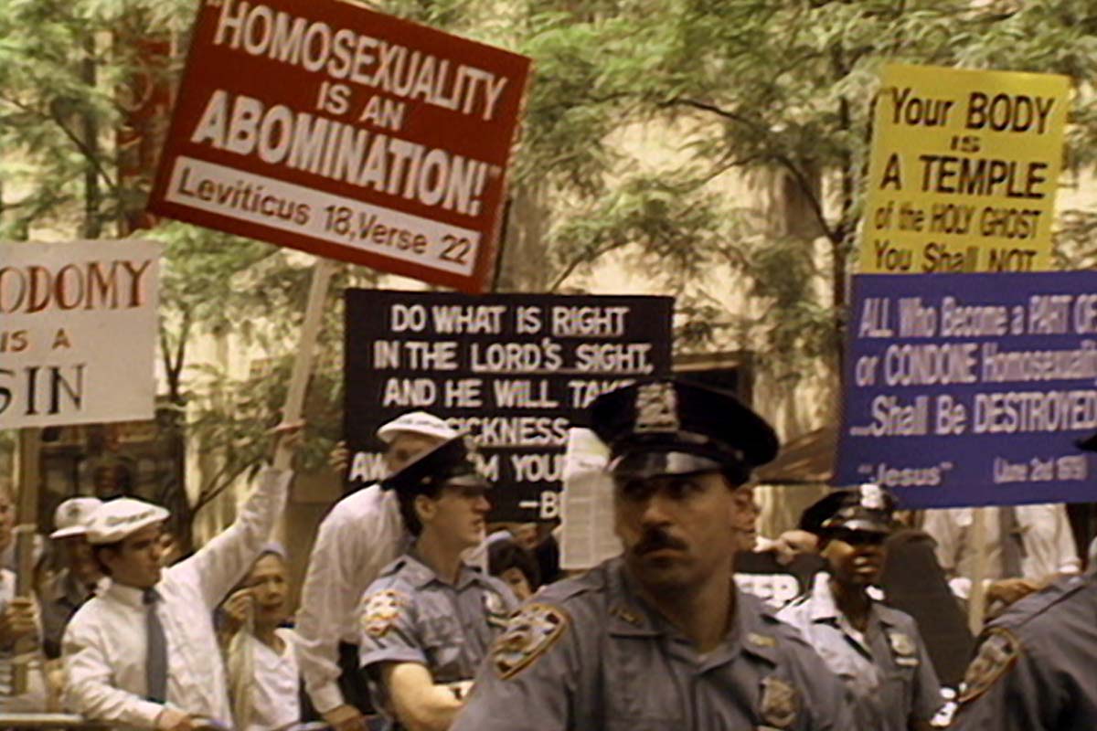 A scene from an anti-gay rights rally with protestors holding up homophobic signs. There are policemen present. From Marlon Riggs’ ‘Tongues Untied.’ Courtesy of The Criterion Collection.