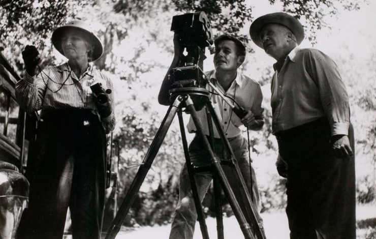 Frances Flaherty (left), a woman wearing a hat and holding equipment, and husband Robert, a man by her side, while filming 'Louisiana Story.'