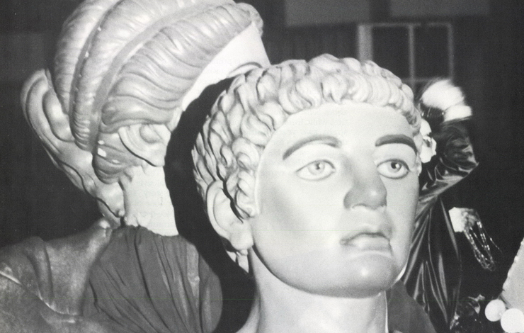 A black and white face of a statue of a man. 'The World's Most Celebrated Carnival' from a different angle. 