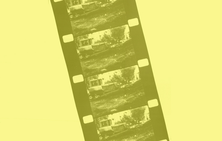 A film strip of a tractor with a yellow cast over it, mocking socialist realism in 'Tractors.'