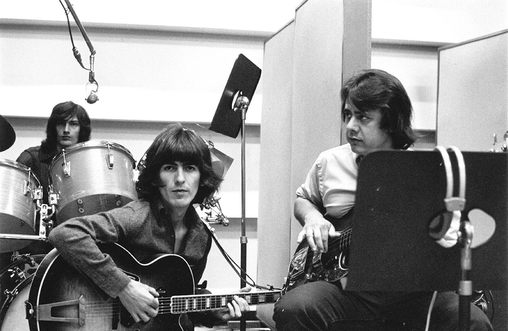 George Harrison (center) in a session with Wrecking Crew member Joe Osborne (right). From Denny Tedesco’s 'The Wrecking Crew'. Courtesy of Magnolia Pictures