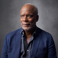 An older Black man with short gray hair and facial hair.