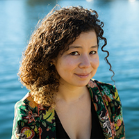 An Asian American woman with curly brown hair.  