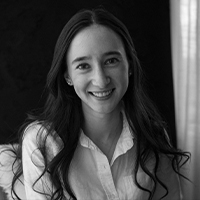 A black and white portrait of a woman with light skin and dark long hair.