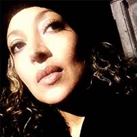 A woman of Mexican and Ethiopian descent with long dark hair.