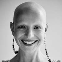 A black and white portrait of a woman with light skin who is bald.