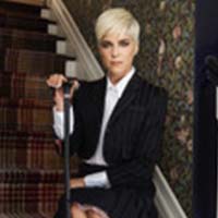 A woman with light skin and short blond hair.