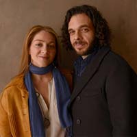 Woman in blue scarf with man in dark jacket. 