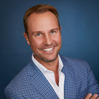 A man with light skin and short brown hair and facial hair.